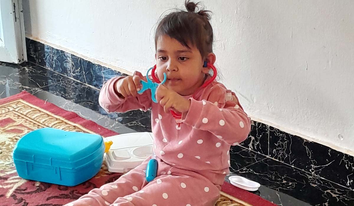 toddler playing with plastic toys